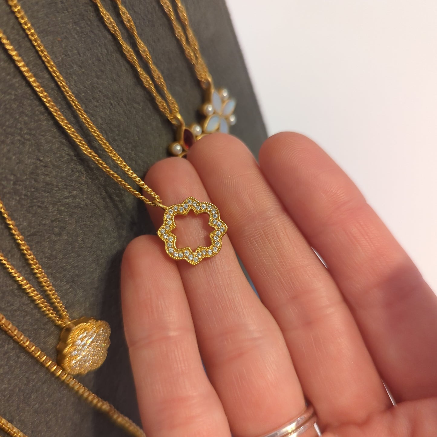 Odette Solitaire Necklace by Julie Vos. Pavé classic quatrefoil shape with a bit of negative center space. 24K gold plate, cubic zirconia, measures 16.5-17.5 inch adjustable length. Charm measures 0.7 inch length. Shop at The Painted Cottage in Edgewater, MD