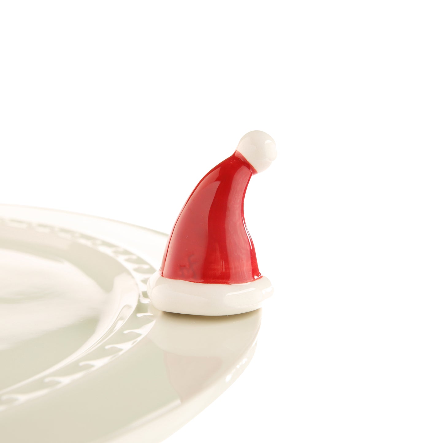 Nora Fleming Santa Stops Here mini. Red and white Santa hat. Shop at The Painted Cottage located in Edgewater, MD.