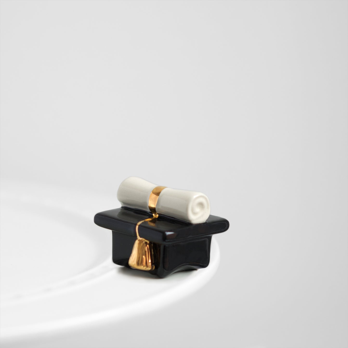 A64 Nora Fleming Top of the Class blk/wh/gold graduation mini available at The Painted Cottage in Edgewater, MD