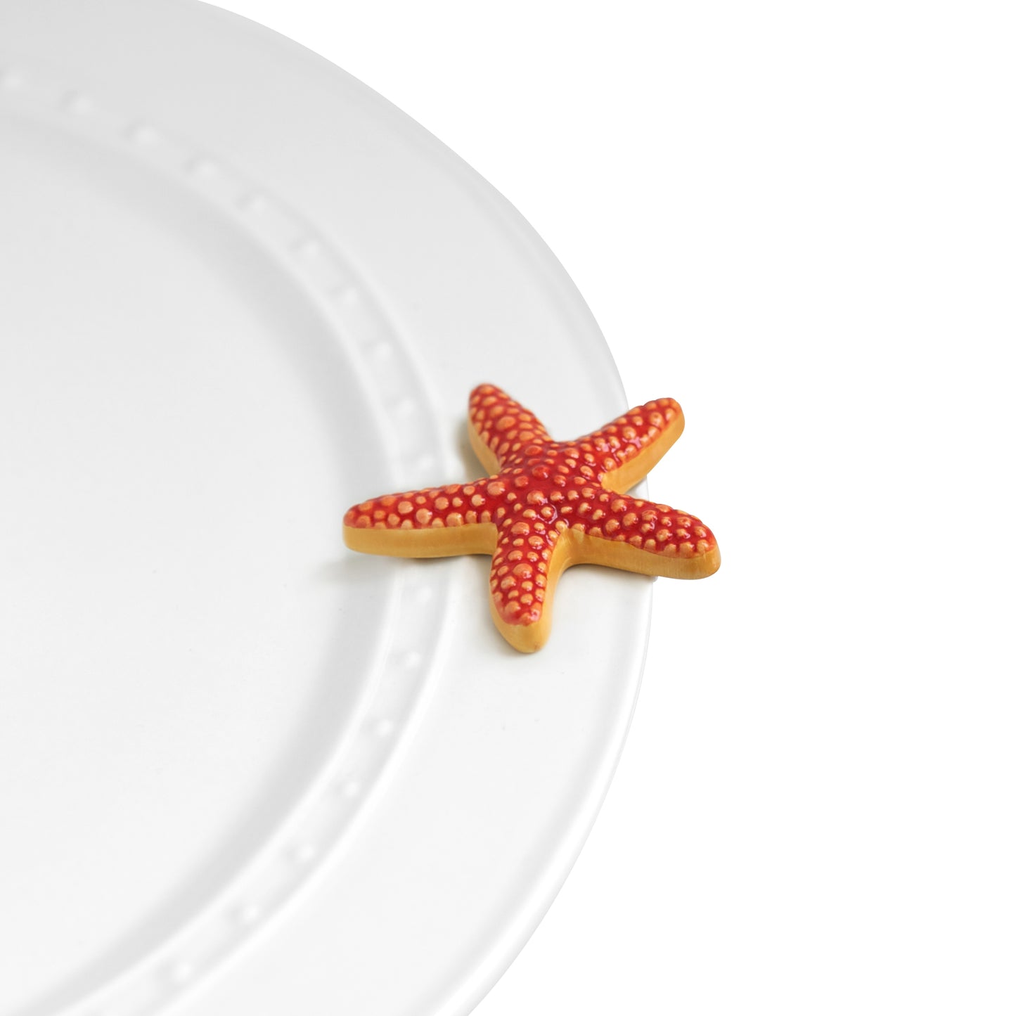 A66 Nora Fleming Sea Star mini features a coral red starfish. Shop at The Painted Cottage an Annapolis boutique.