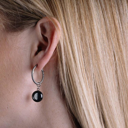 Moonglow Carina Hoop earrings features two 10mm moon images on 20mm stainless steel hoops with snap-down bar closure. Boasts two unique moon phases based on your special date. Shop at The Painted Cottage in Edgewater, MD.