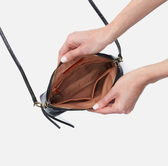 The Reeva crossbody in black by HOBO is perfect for everything from mornings at the coffeeshop to happy hour with friends. Adjust the strap to wear as a crossbody, short shoulder or wristlet for three looks in one! Crafted in our Vintage Hide leather that only gets more beautiful over time with use and wear. Shop for it at the Painted Cottage in Edgewater, MD
