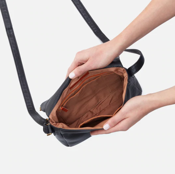 The Fern Messenger crossbody by HOBO pairs the iconic zipper closure with a foldover top and spacious interior, perfect for days when you need to carry a little more. Crafted in our Velvet Pebbled Hide, our softest and most casual leather that only gets more beautiful over time. Check it out at the Painted Cottage in Edgewater, MD