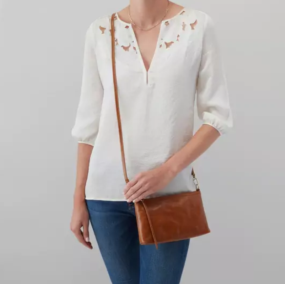 This iconic and convertible Darcy Truffle by HOBO can be worn three ways: crossbody, baguette bag and wristlet. Crafted in our Vintage Hide leather that only gets more beautiful over time with use and wear. For sale at the Painted Cottage in Edgewater, MD