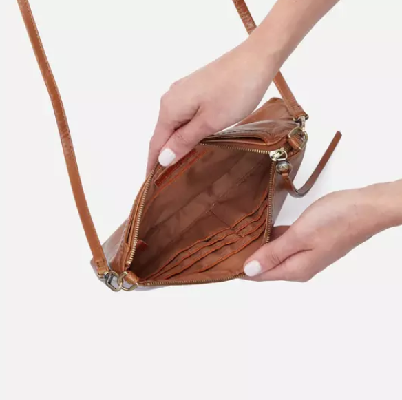 This iconic and convertible Darcy Truffle by HOBO can be worn three ways: crossbody, baguette bag and wristlet. Crafted in our Vintage Hide leather that only gets more beautiful over time with use and wear. For sale at the Painted Cottage in Edgewater, MD