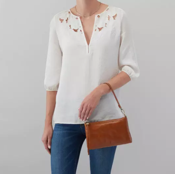 This iconic and convertible Darcy Truffle by HOBO can be worn three ways: crossbody, baguette bag and wristlet. Crafted in our Vintage Hide leather that only gets more beautiful over time with use and wear. For sale at the Painted Cottage in Edgewater, MD