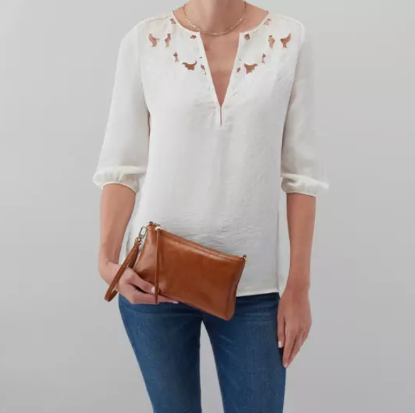 This iconic and convertible Darcy Truffle by HOBO can be worn three ways: crossbody, baguette bag and wristlet. Crafted in our Vintage Hide leather that only gets more beautiful over time with use and wear. For sale at the Painted Cottage in Edgewater, MD
