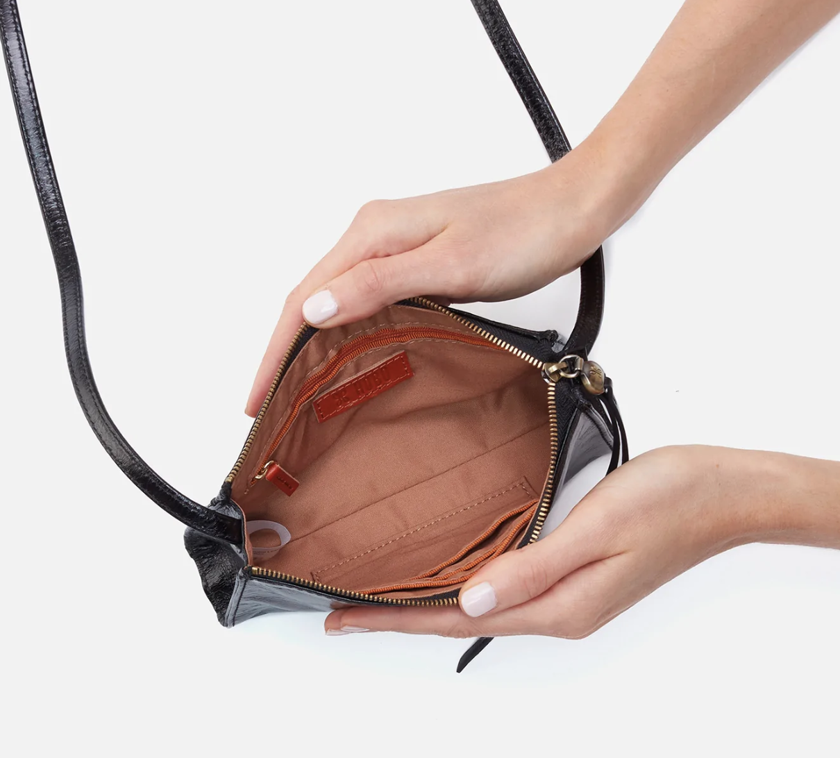 The Jewel in black by HOBO is a small crossbody designed to hold the essentials. It has a compact size with enough space for your phone, keys and cards. Check it out at the Painted Cottage in Edgewater, MD