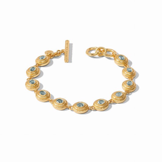 Tudor Tennis Bracelet - Peacock Blue by Julie Vos. Adjustable-length tennis bracelet centers on an oval rose cut stone set within lightly hammered gold walls.  24K gold plate, imported glass/CZ Circumference: 7.1 / 7.6 inches (adjustable) Link width: 0.4 inches Closure: Toggle. Shop at The Painted Cottage in Edgewater, MD.