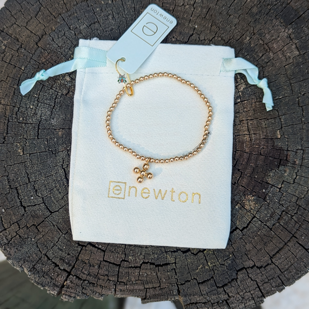 Classic Gold 3mm Bracelet - 4mm Signature Cross Charm by eNewton. Made with 3mm 14kt gold-filled beads and signature cross charm. Shop at The Painted Cottage in Edgewater, MD.