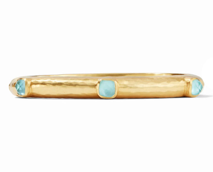 Catalina Hinge Bangle Baha Blue by Julie Vos. Lightly hammered bangle showcasing six stations of rose-cut imported glass stone adornments. 24K gold plate, imported glass, mother of pearl 2.5 inch diameter. Shop at The Painted Cottage in Edgewater, MD.