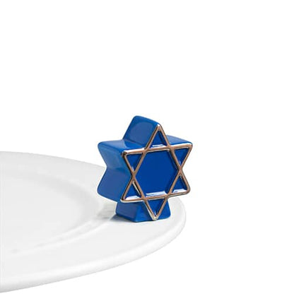 A122 Nora Fleming Blue Star mini. Celebrate Hanukkah with this blue and silver accent star of David mini. Shop at The Painted Cottage in Edgewater MD.