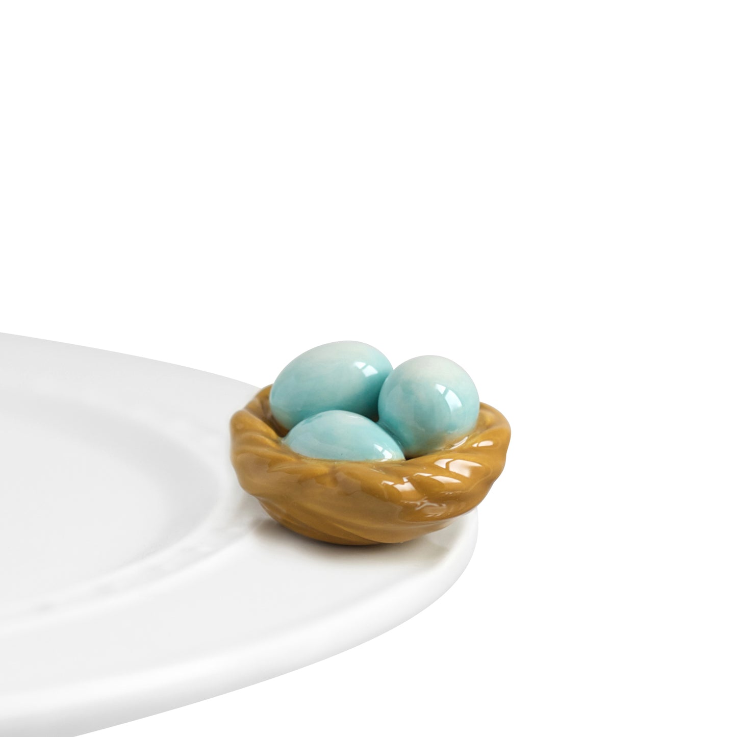 Nora Fleming Robin's Egg blue mini basket with three blue eggs. Shop at The Painted Cottage in Edgewater, MD.