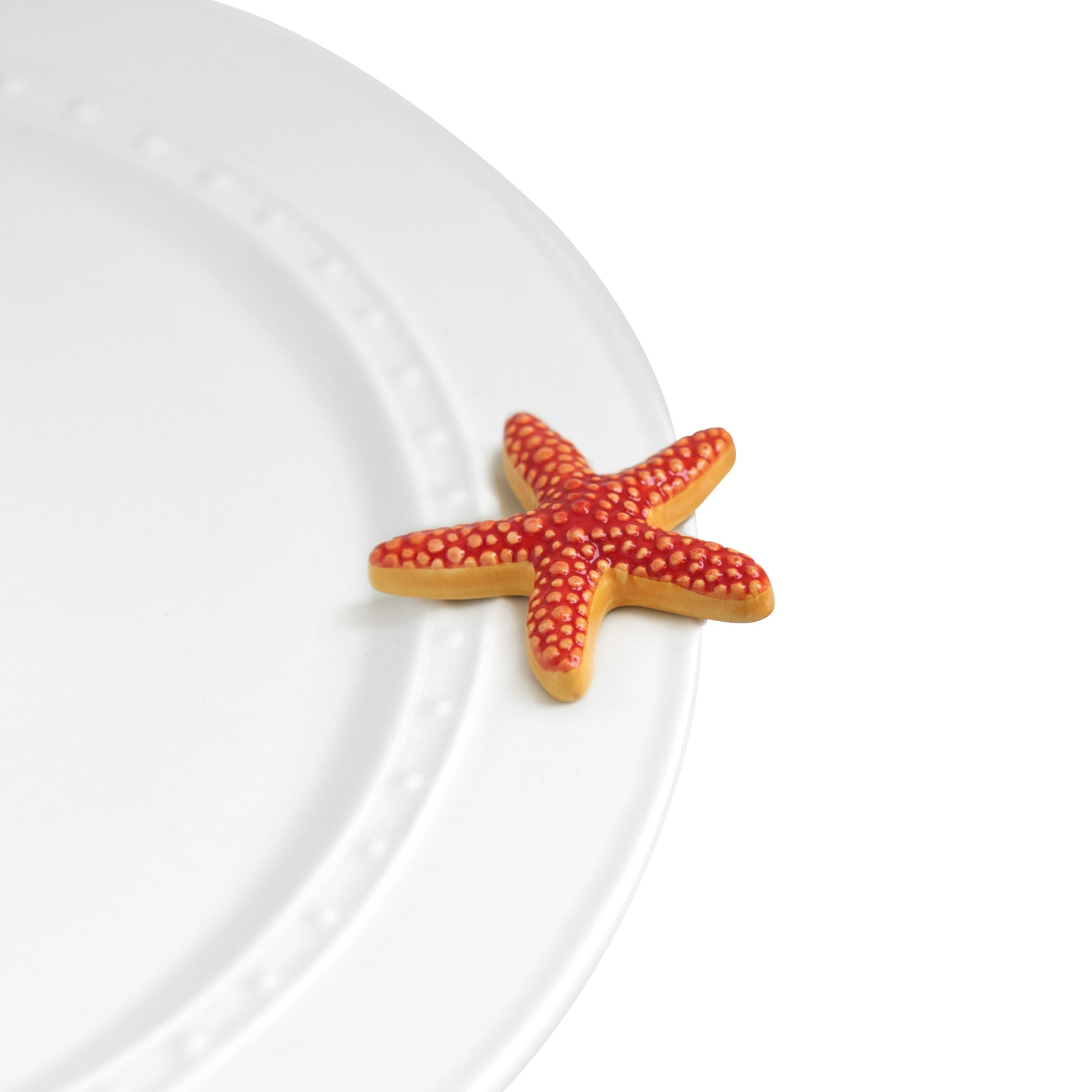 A66 Nora Fleming Sea Star mini features a coral red starfish. Shop at The Painted Cottage an Annapolis boutique.