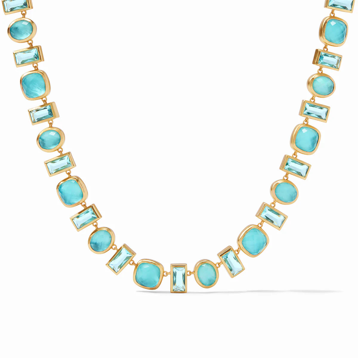 Antonia Tennis Necklace Iridescent Bahamian Blue by Julie Vos features alternating Bahamian blue stones, each framed in gold finish that resembles a paving stone path. Measures 19-19.75 inches. 24K gold plate. Shop at The Painted Cottage in Edgewater, MD.