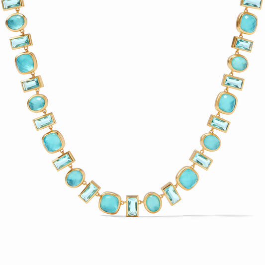 Antonia Tennis Necklace Iridescent Bahamian Blue by Julie Vos features alternating Bahamian blue stones, each framed in gold finish that resembles a paving stone path. Measures 19-19.75 inches. 24K gold plate. Shop at The Painted Cottage in Edgewater, MD.