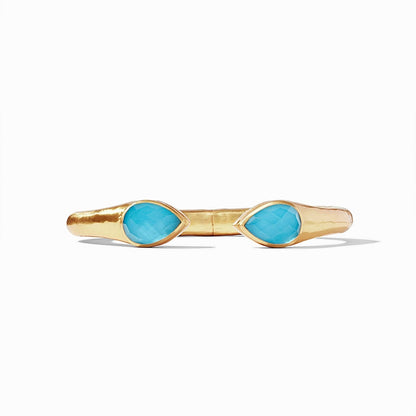 Avalon Cuff Iridescent Pacific Blue by Julie Vos features pear-shaped endcaps of rose-cut imported glass on a gilded shank. Hinged to fit all wrists in 24K gold plate. Shop at The Painted Cottage an Annapolis boutique.