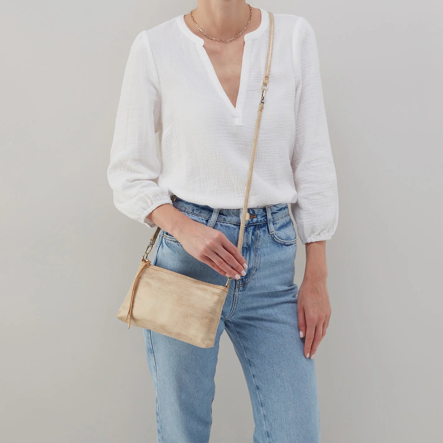 This iconic and convertible Darcy Crossbody Gold Leaf by HOBO can be worn three ways: crossbody, baguette bag and wristlet. Available at the Painted Cottage in Edgewater, MD