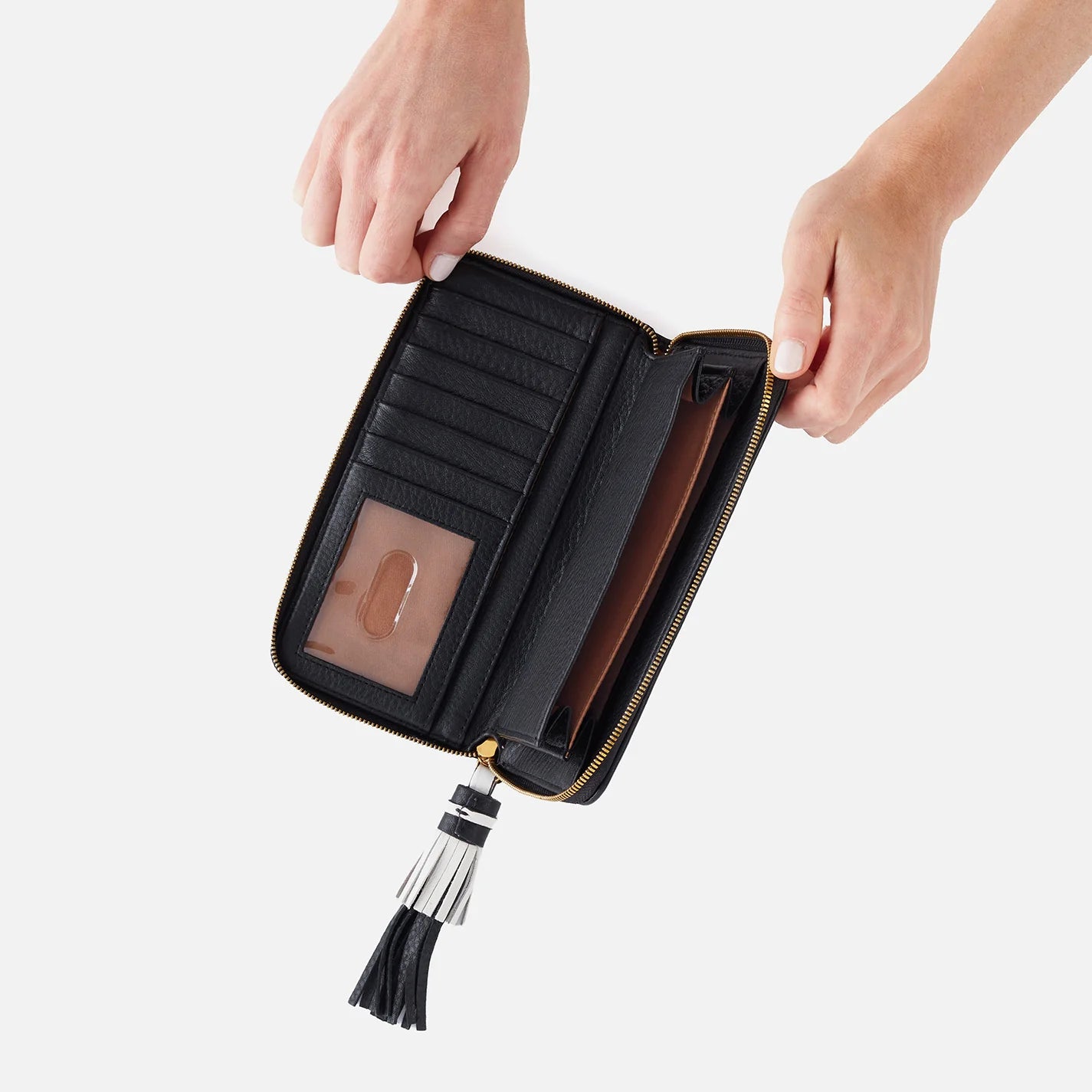 The Nila Large Zip Around Wallet in black is a continental design with interior organization for your cash and cards and a leather tassel zipper for added style and functionality. Check it out at the Painted Cottage in Edgewater, MD
