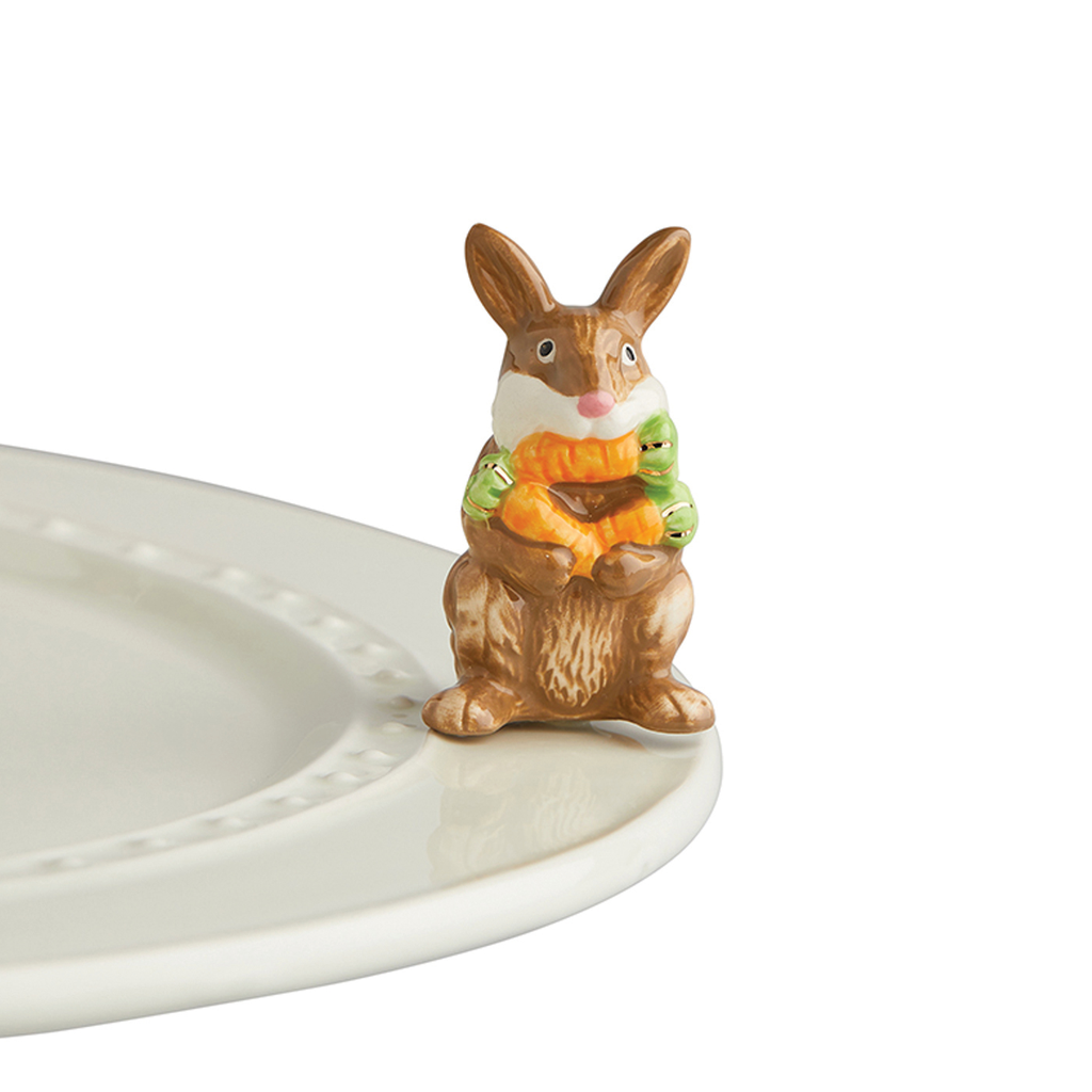 Nora Fleming Funny Bunny brown bunny holding its carrots. Shop at The Painted Cottage a Maryland Boutique