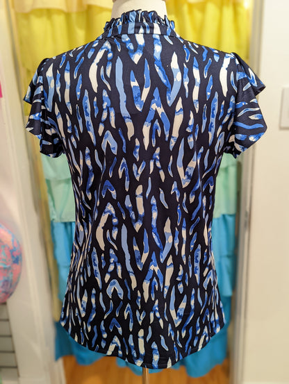 Navy/multi Tahiti Claire top with button front and ruffle collar and sleeves in poly/spandex
