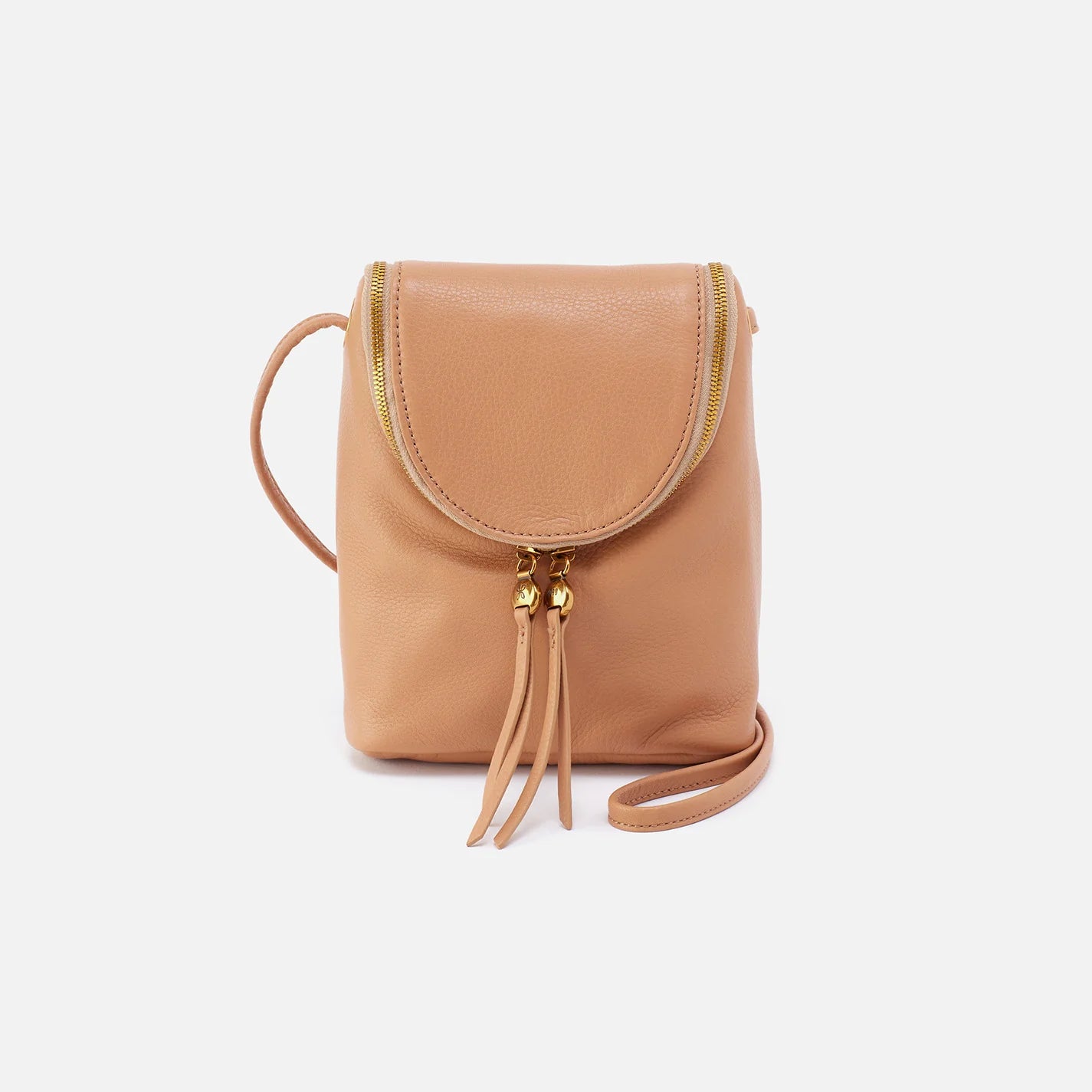 The Fern Crossbody in sandstorm has a double-zipper closure for easy access, an endlessly adjustable strap, and an exterior slip pocket for your phone. Check it out at the Painted Cottage in Edgewater, MD