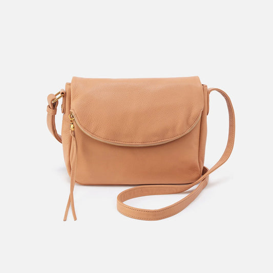 The Fern Messenger Bag in sandstorm by HOBO has two interior compartments for organization, an adjustable crossbody strap and an exterior slip pocket for your phone. Check it out at the Painted Cottage in Edgewater, MD