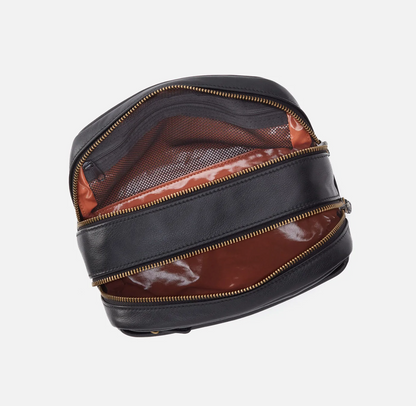 The Leather Men's Travel Kit in black has a two zipper compartments and a lined interior perfect for keeping your toiletries organized. For sale at the Painted Cottage in Edgewater, MD