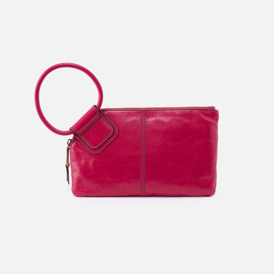 Designed with our signature circular handle, the Sable in fuchsia will securely stow away your essentials as you grab it and go. Crafted in our Vintage Hide leather that only gets more beautiful over time with use and wear. For sale at the Painted Cottage in Edgewater, MD