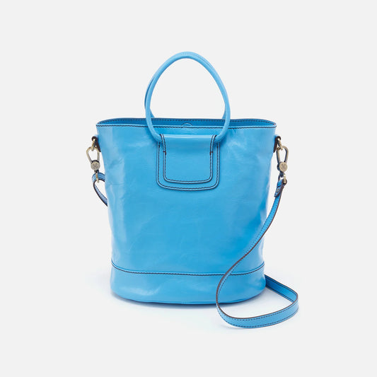 The Sheila in tranquil blue is a leather bucket tote that has a structured shape, roomy interior and removable strap giving you the option to carry as a top handle bag. Available at the Painted Cottage in Edgewater, MD