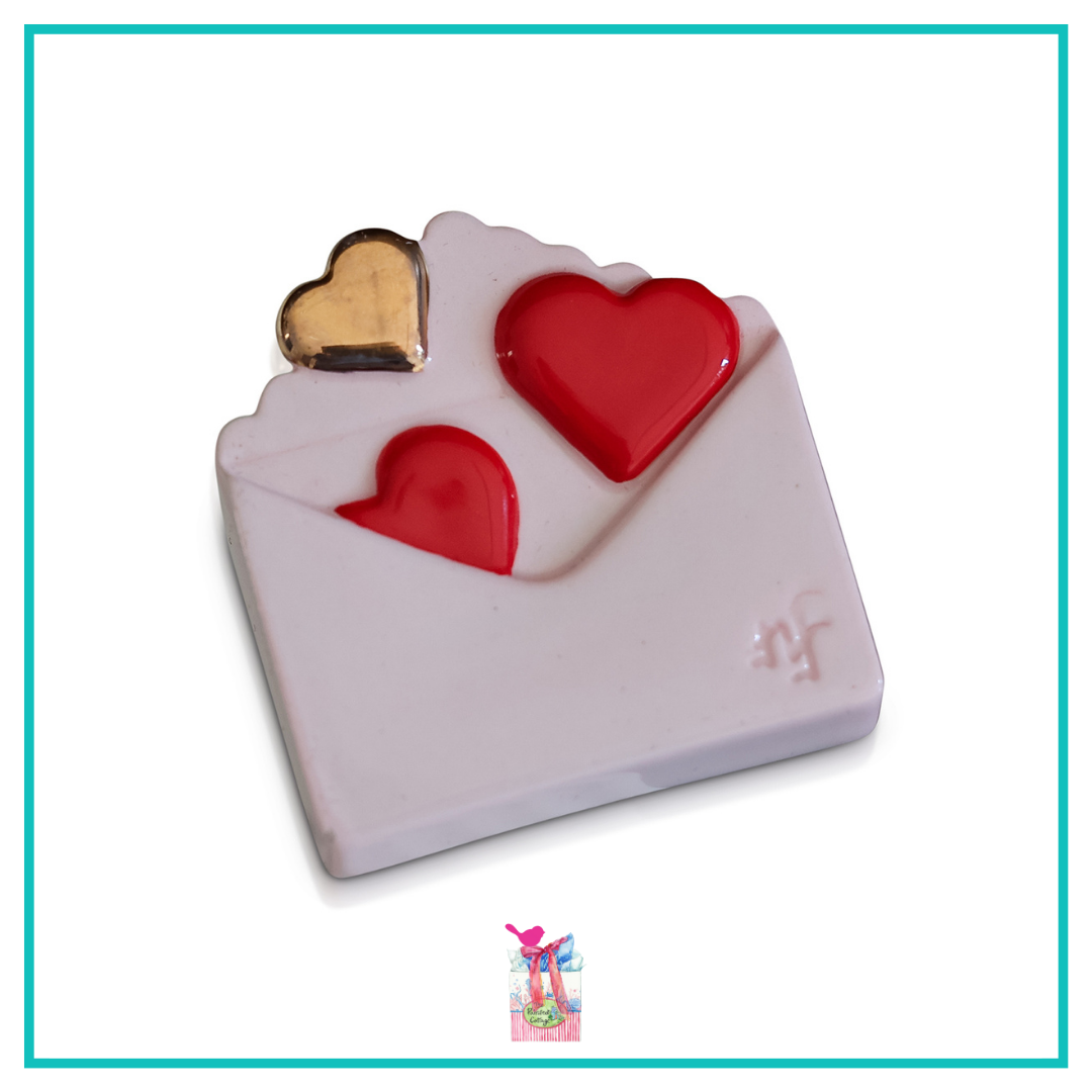 A297 Love Notes Mini by Nora Fleming features white envelope with red and gold hearts. Shop at The Painted Cottage in Edgewater MD.