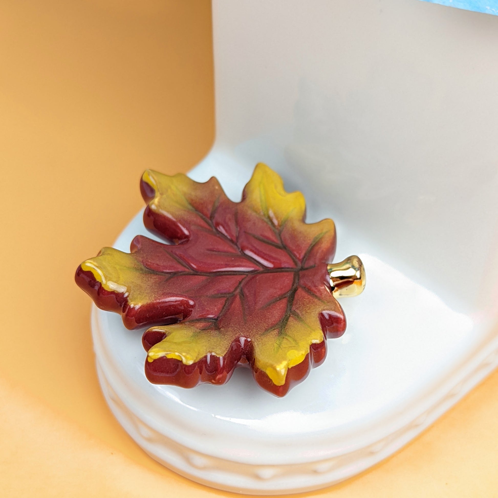 A290 NF Falling For You Mini. Brown and gold maple leaf mini by Nora Fleming. Shop at The Painted Cottage in Edgewater, MD.