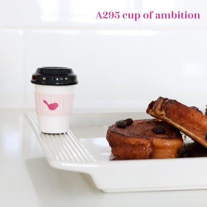 A295 Cup of Ambition Mini by Nora Fleming, Wh/Blk coffee cup with lid features NF pink bird. Shop at The Painted Cottage in Edgewater MD.